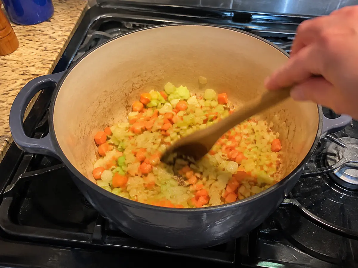 Onion, carrots, and celery softening in olive oil and butter in an enameled Dutch oven.
