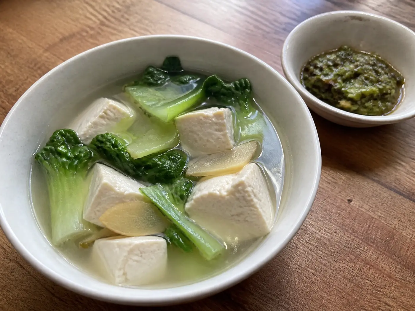 Clear bok choy tofu soup served with roasted green chile dipping sauce