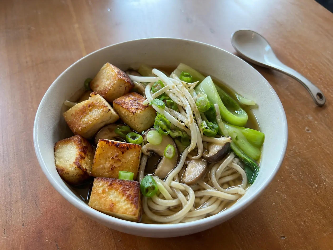 Crispy tofu noodle soup with bok choy, mushrooms, and bean sprouts
