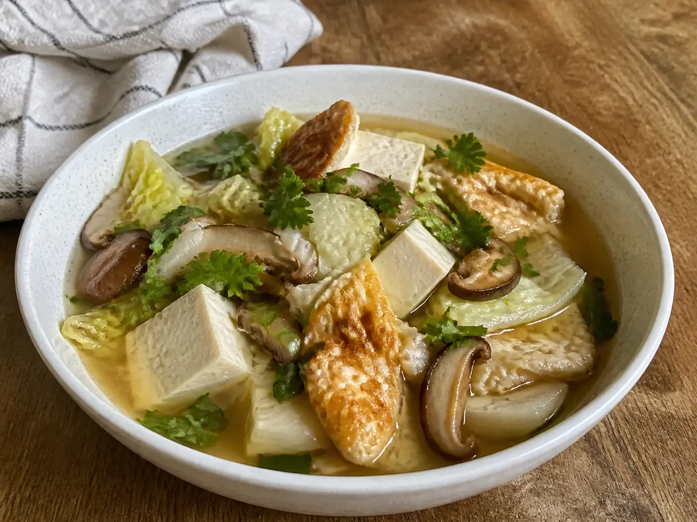 Napa cabbage tofu soup with fried egg, mushrooms, and firm tofu