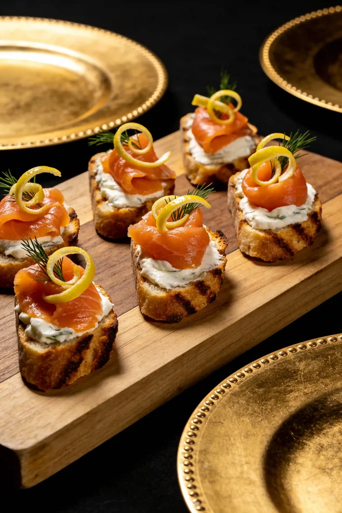 Smoked salmon crostini with creamy spread, dill, and capers for a New Year's Eve appetizer.