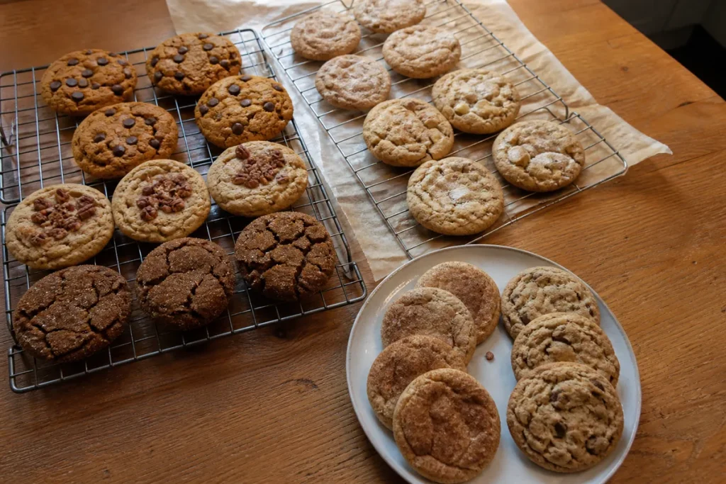 Assorted easy fall cookie recipes including pumpkin, apple, maple, spice, and chocolate cookies on cooling racks.