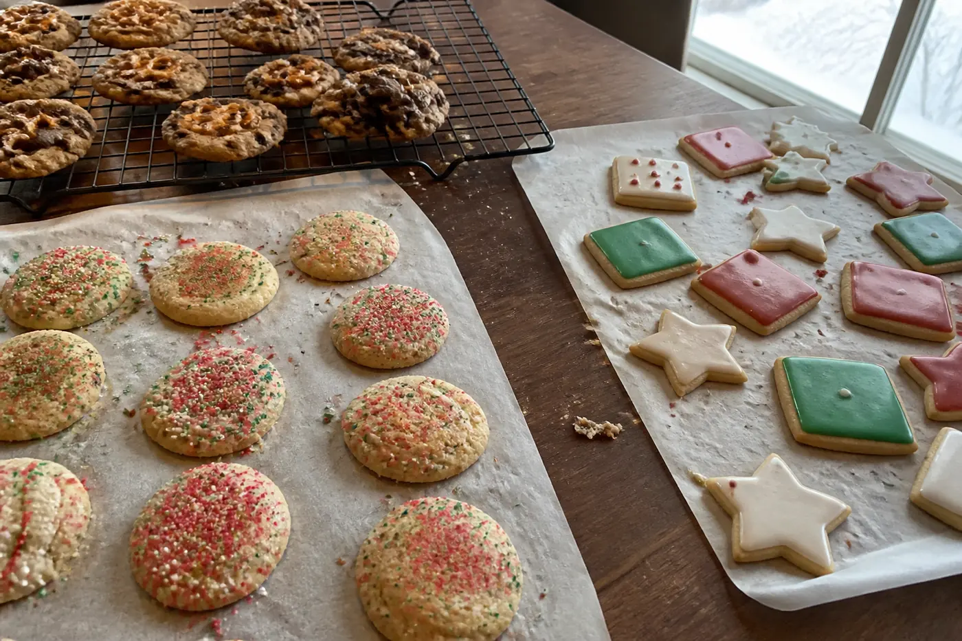 Confetti cookies, loaded sweet-and-salty cookies, and decorated sugar cookies on a home baking table.