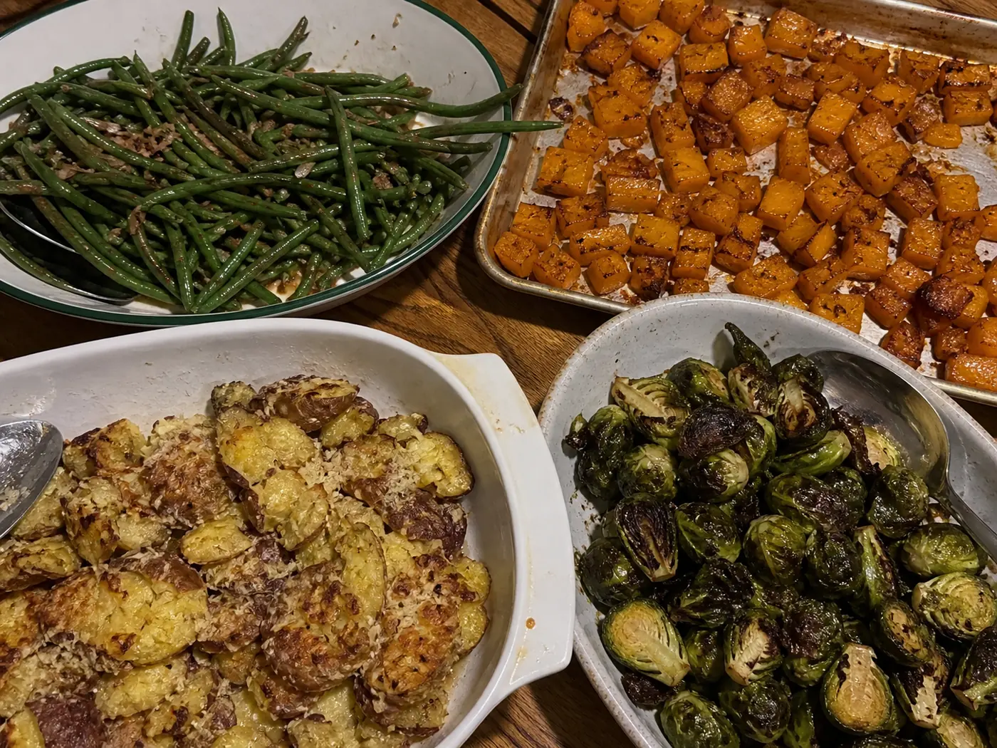 Christmas side dishes with green beans, roasted butternut squash, smashed Parmesan potatoes, and Brussels sprouts