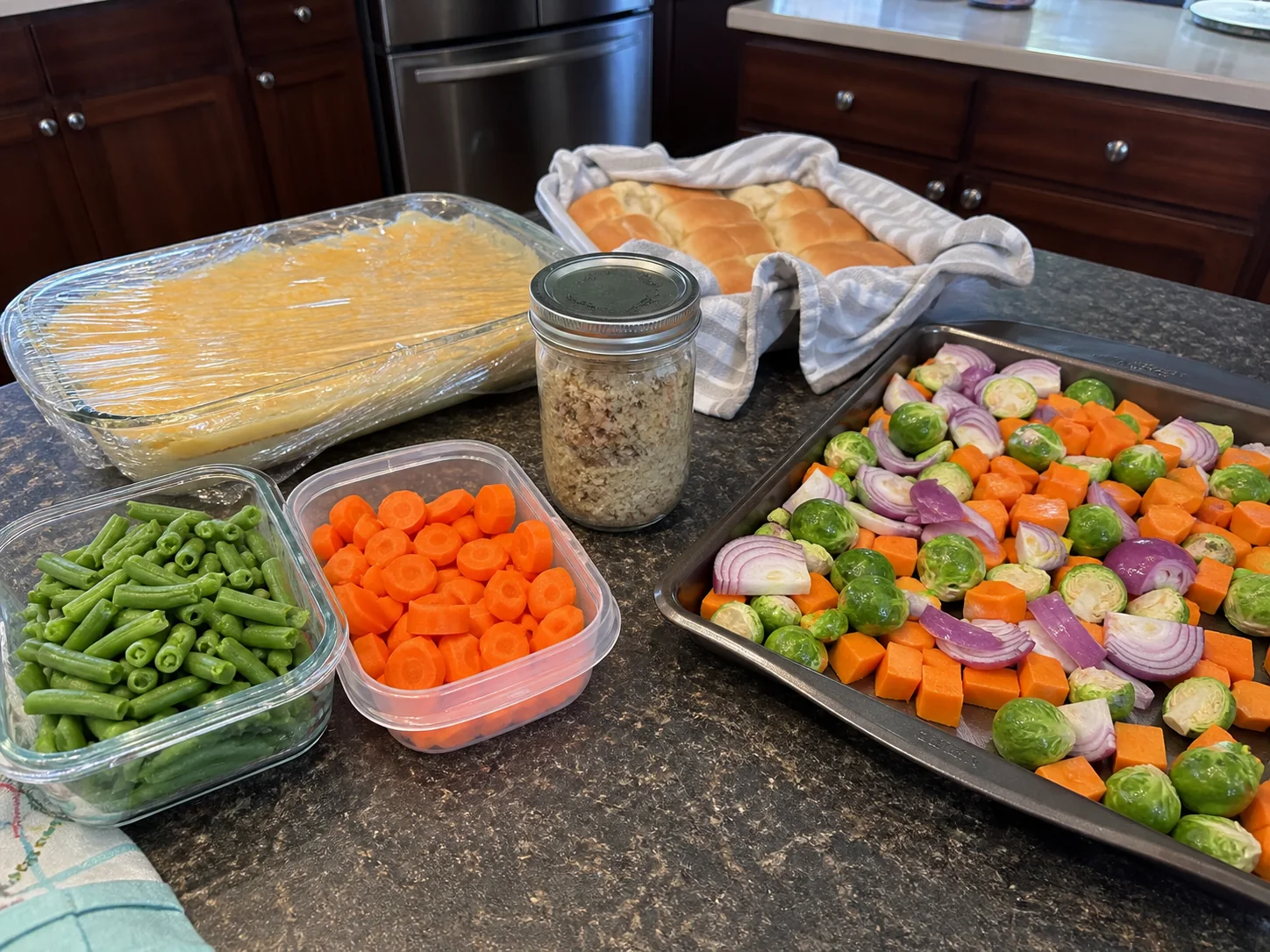 Make-ahead Christmas dinner components organized in practical containers on a home kitchen counter.