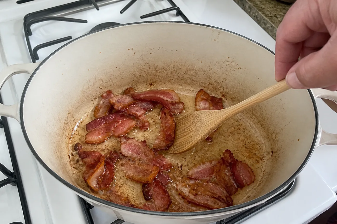 Bacon cooking until crisp in a Dutch oven for loaded baked potato soup