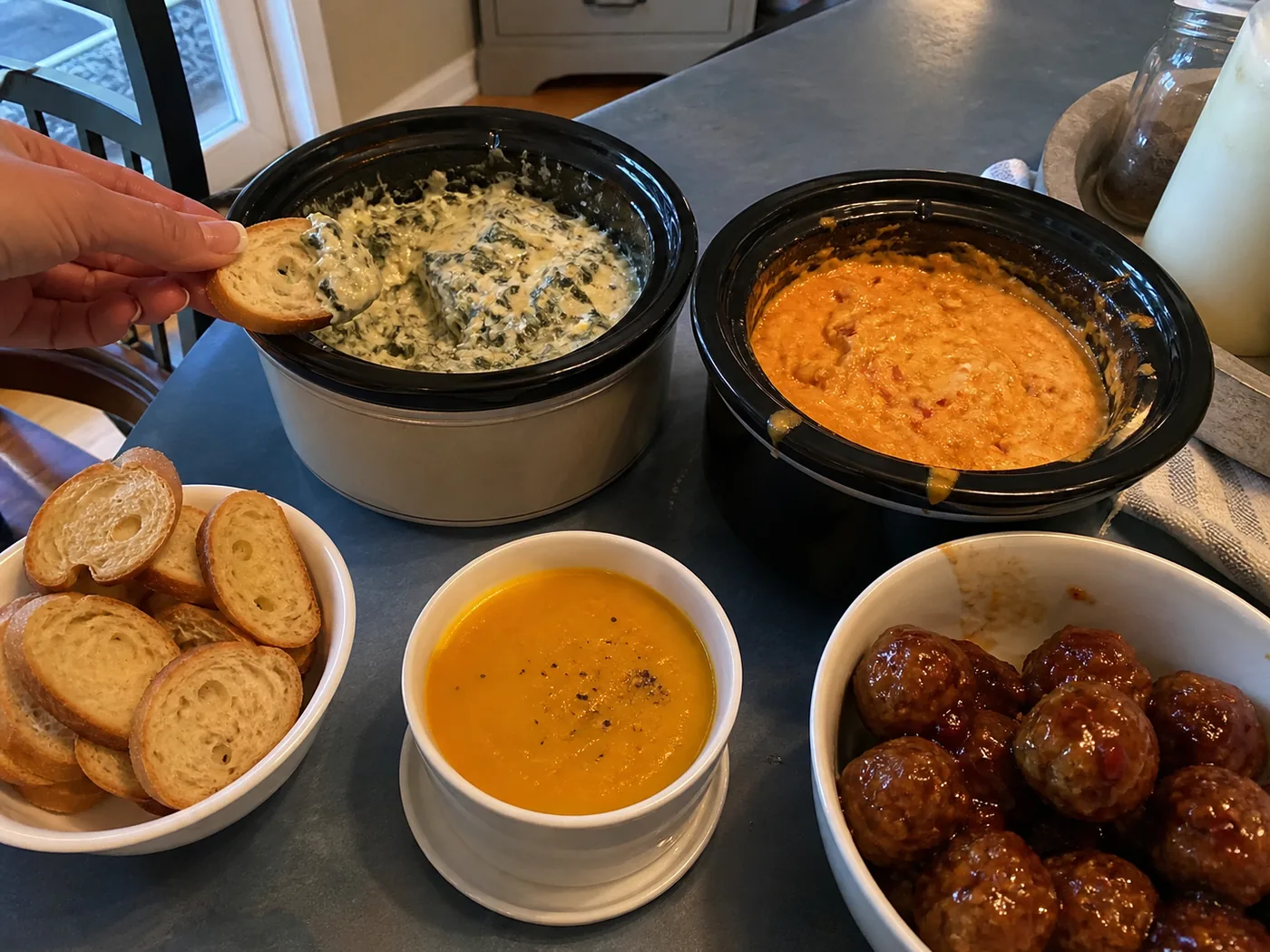 Butternut squash soup, spinach artichoke dip, buffalo chicken dip, and cocktail meatballs in slow cookers.