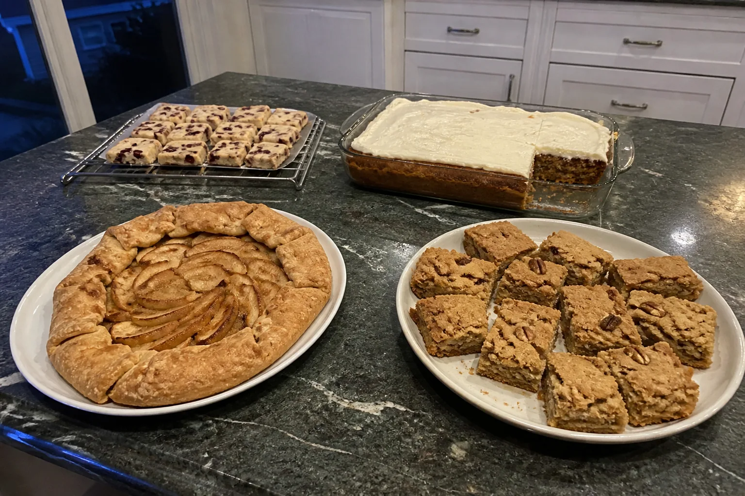 Fall dessert table with apple galette, pumpkin sheet cake, maple pecan blondies, and cranberry orange shortbread.