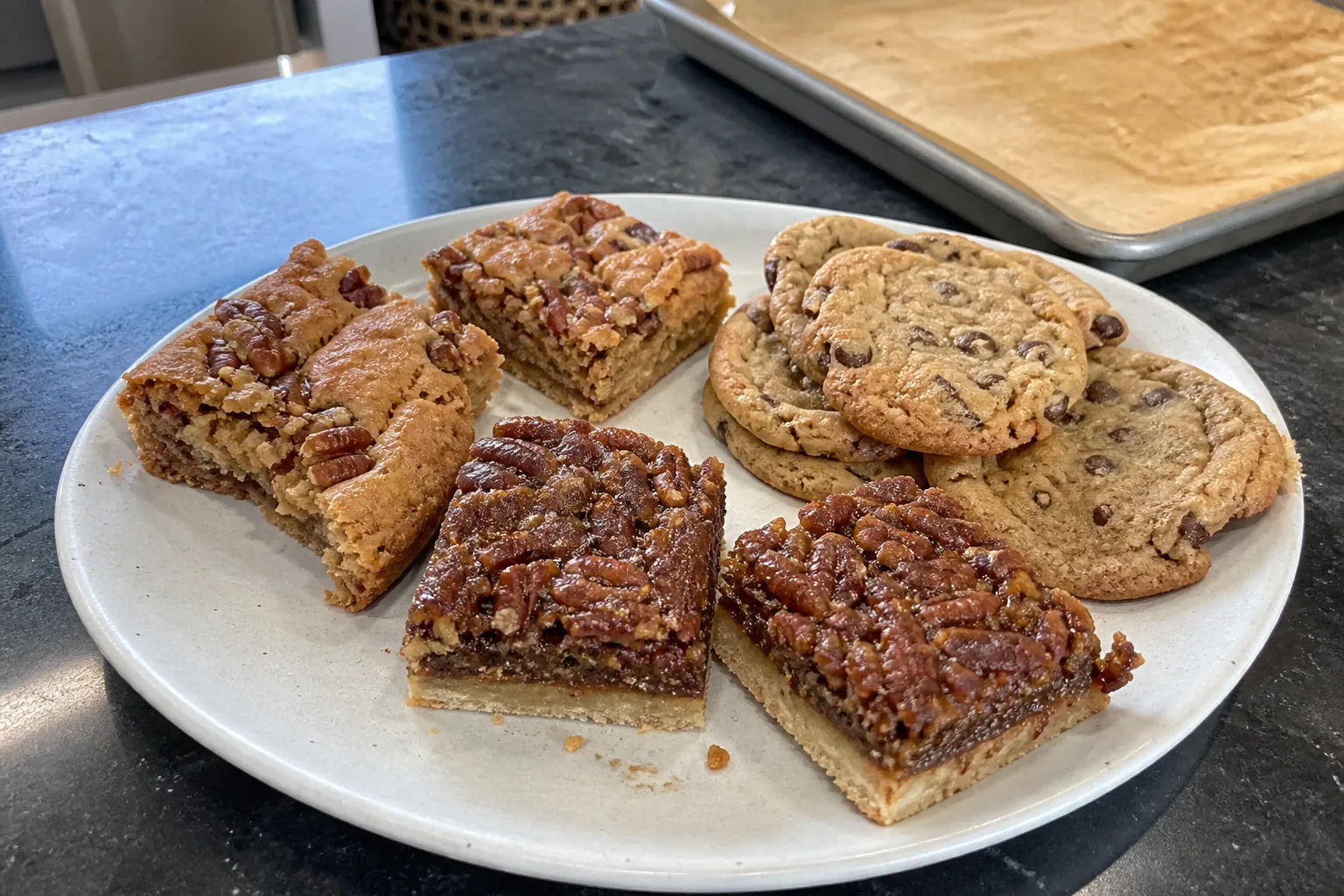 Maple pecan blondies, pecan pie bars, and brown butter chocolate chip cookies on a home kitchen counter.