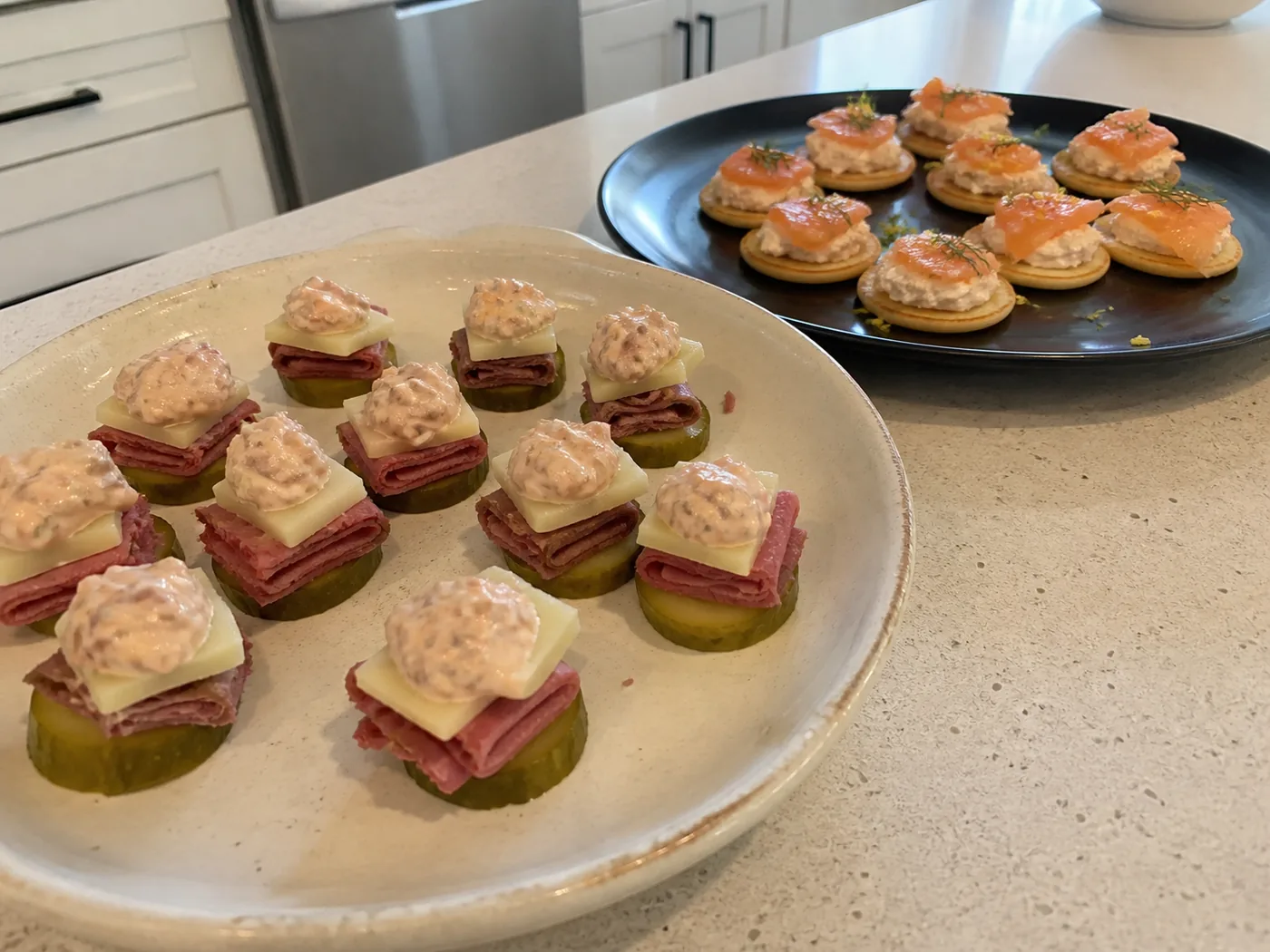 Reuben pickle bites and smoked salmon keto blinis served as low-carb Thanksgiving appetizers