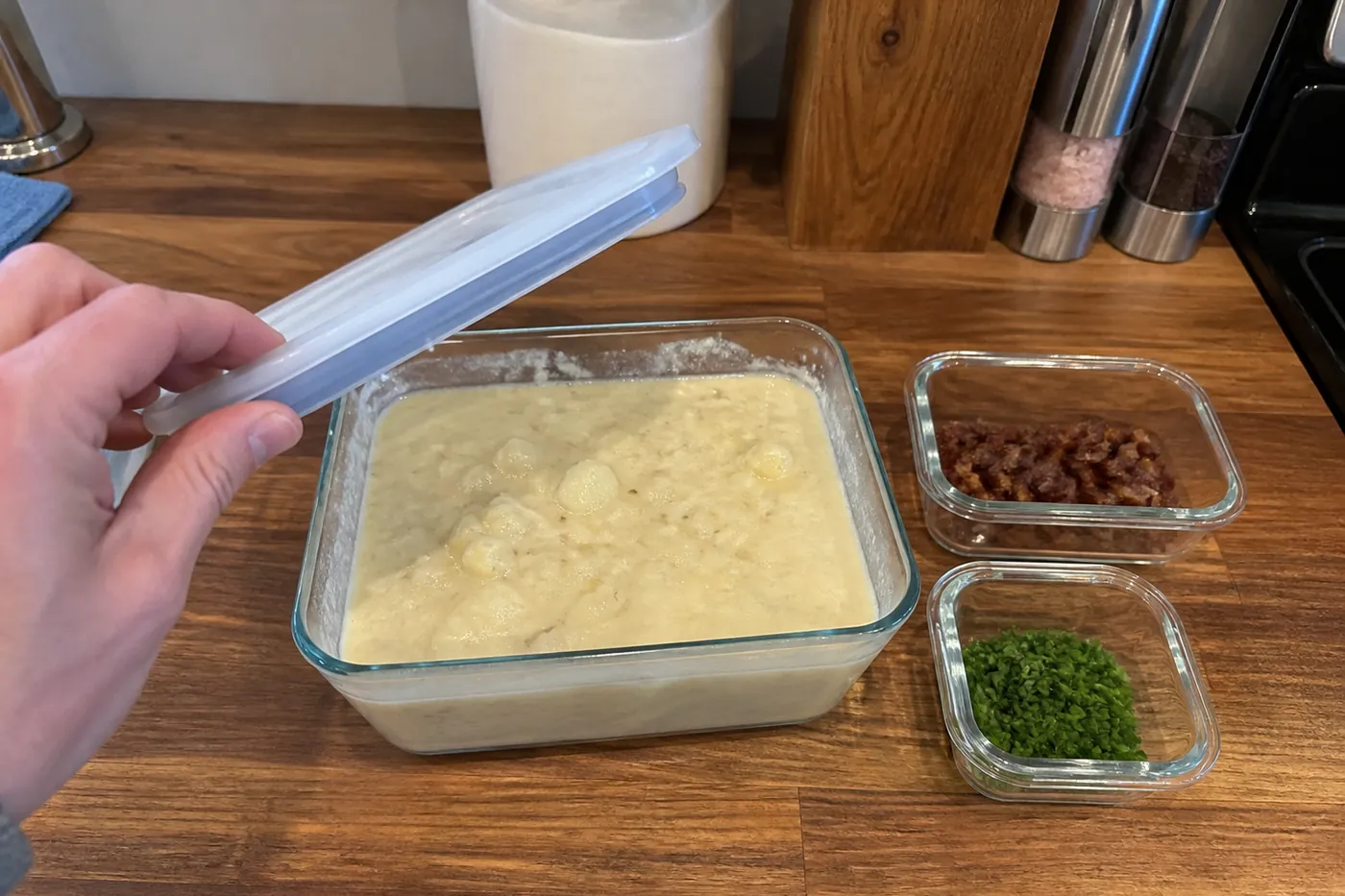 Leftover loaded baked potato soup stored in an airtight glass container for reheating