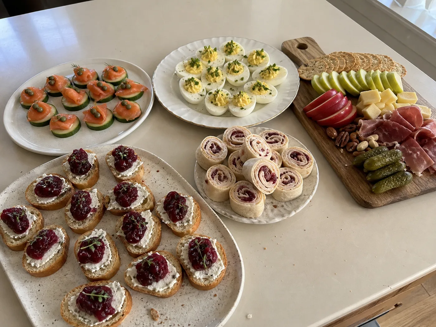 Cranberry goat cheese crostini, smoked salmon cucumber bites, deviled eggs, turkey pinwheels, and an autumn charcuterie board