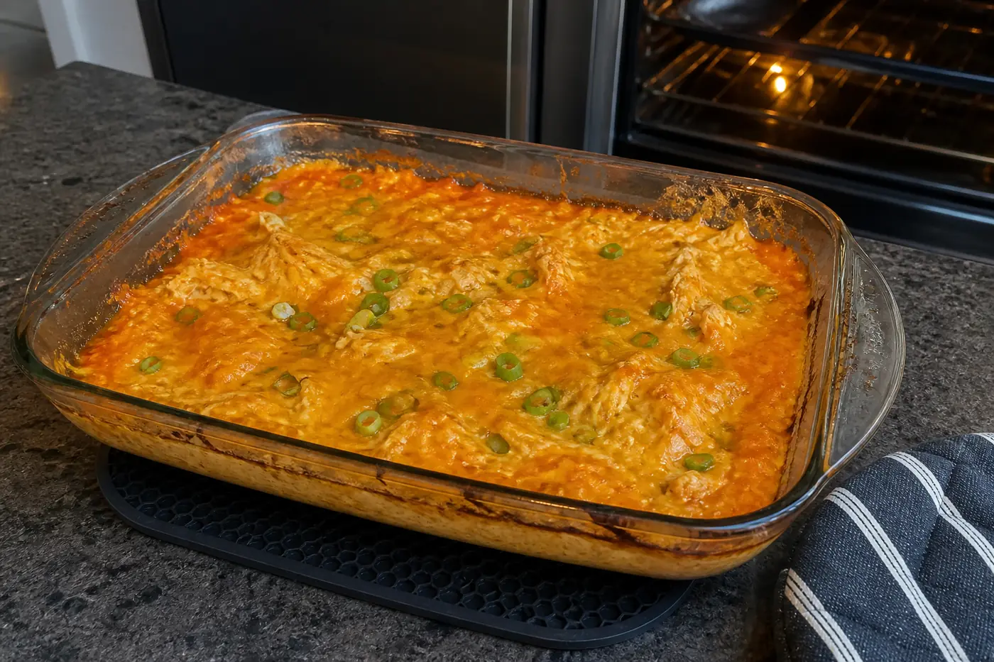 Hot buffalo chicken dip bubbling around the edges with melted cheddar on top