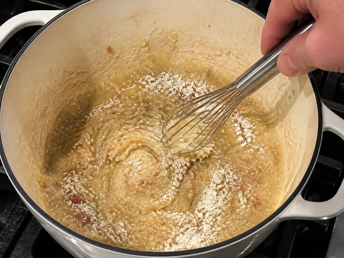 Chopped onion and flour being cooked into a pale roux for potato soup