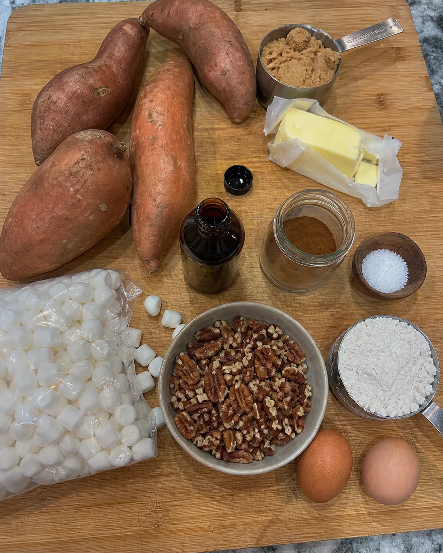 Sweet potatoes, brown sugar, butter, cinnamon, vanilla, marshmallows, pecans, flour, and eggs for Thanksgiving casserole