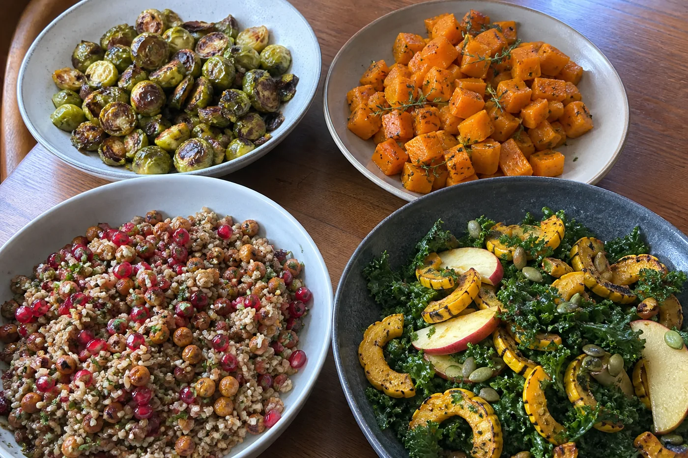 Roasted Brussels sprouts, maple squash, pomegranate rice salad, and delicata squash kale salad