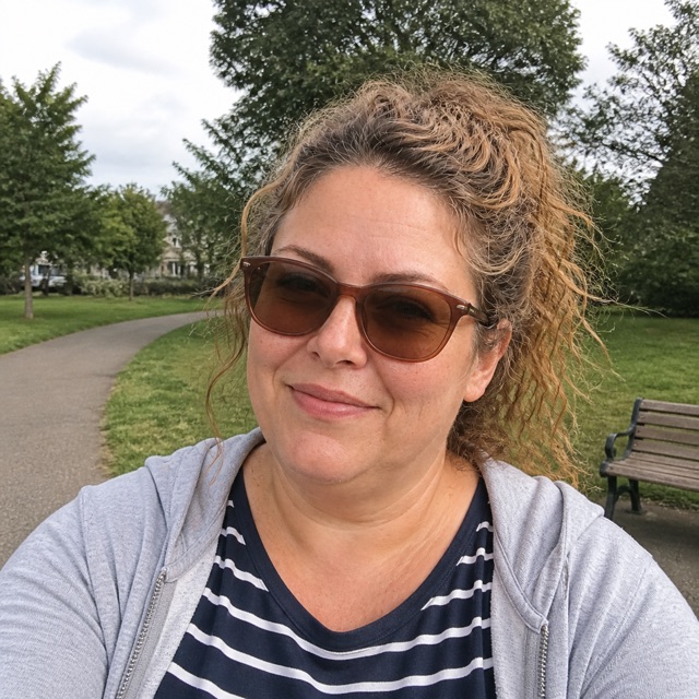 Emily Carter outdoors in sunglasses and casual clothes